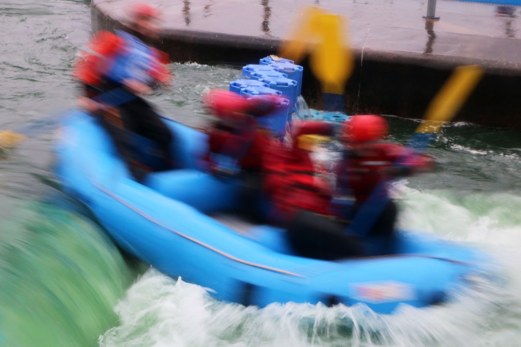 A group of people riding on the back of a boat

Description automatically generated